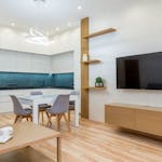 A sleek, contemporary kitchen and living room with minimalist design, featuring clean lines and bright lighting.